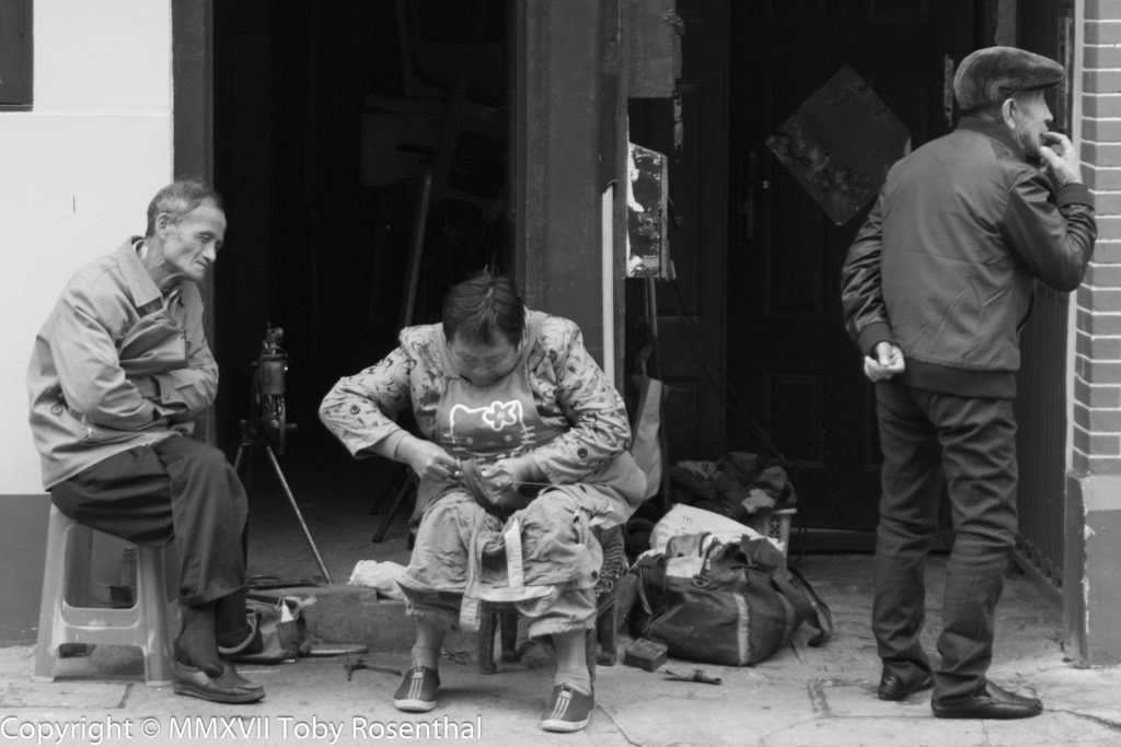 Street photography Shoe Repair On The Street Downtown Shanghai